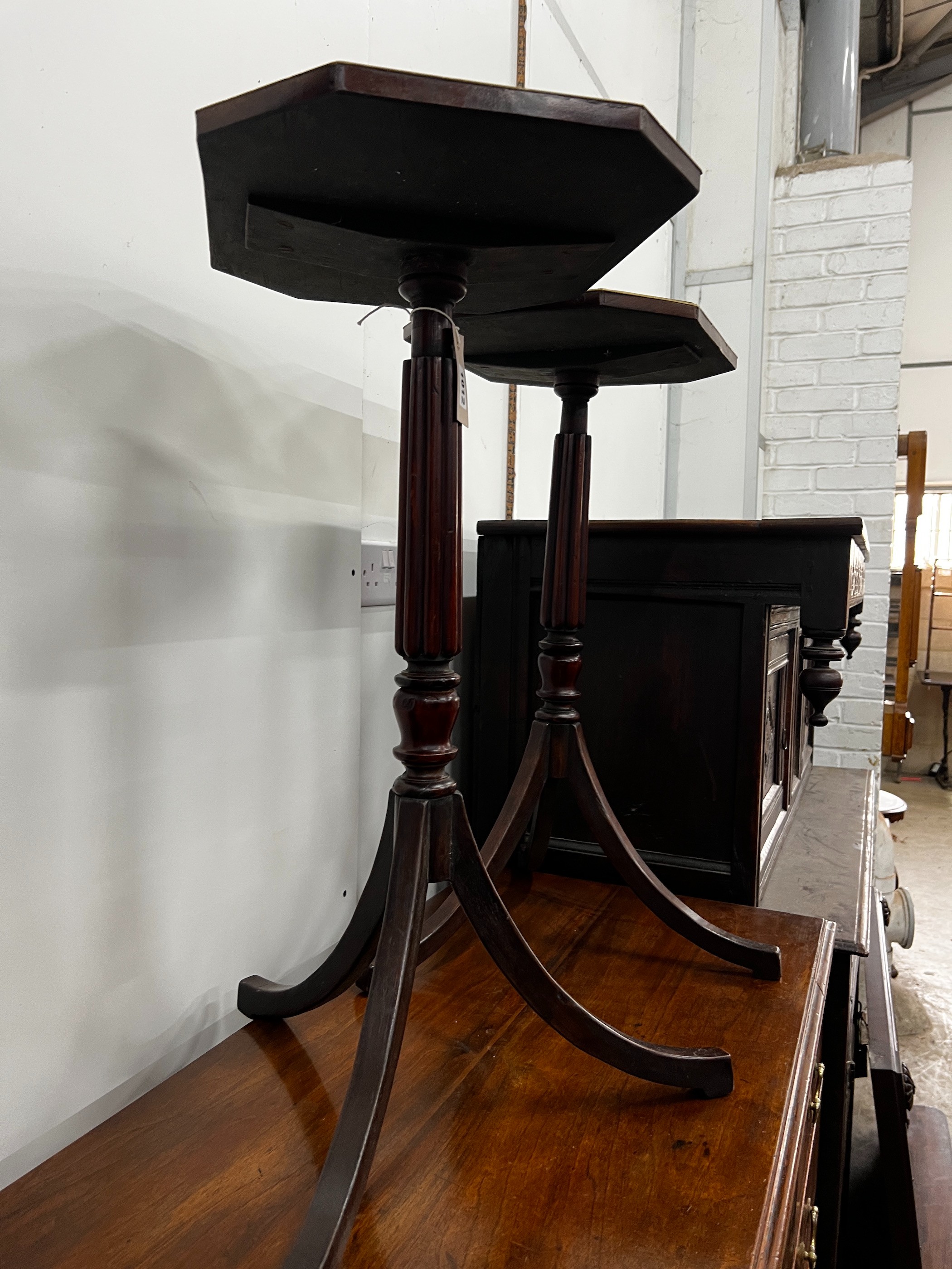 A pair of Regency style brass mounted mahogany octagonal top tripod tables, width 39cm, depth 32cm, height 71cm
